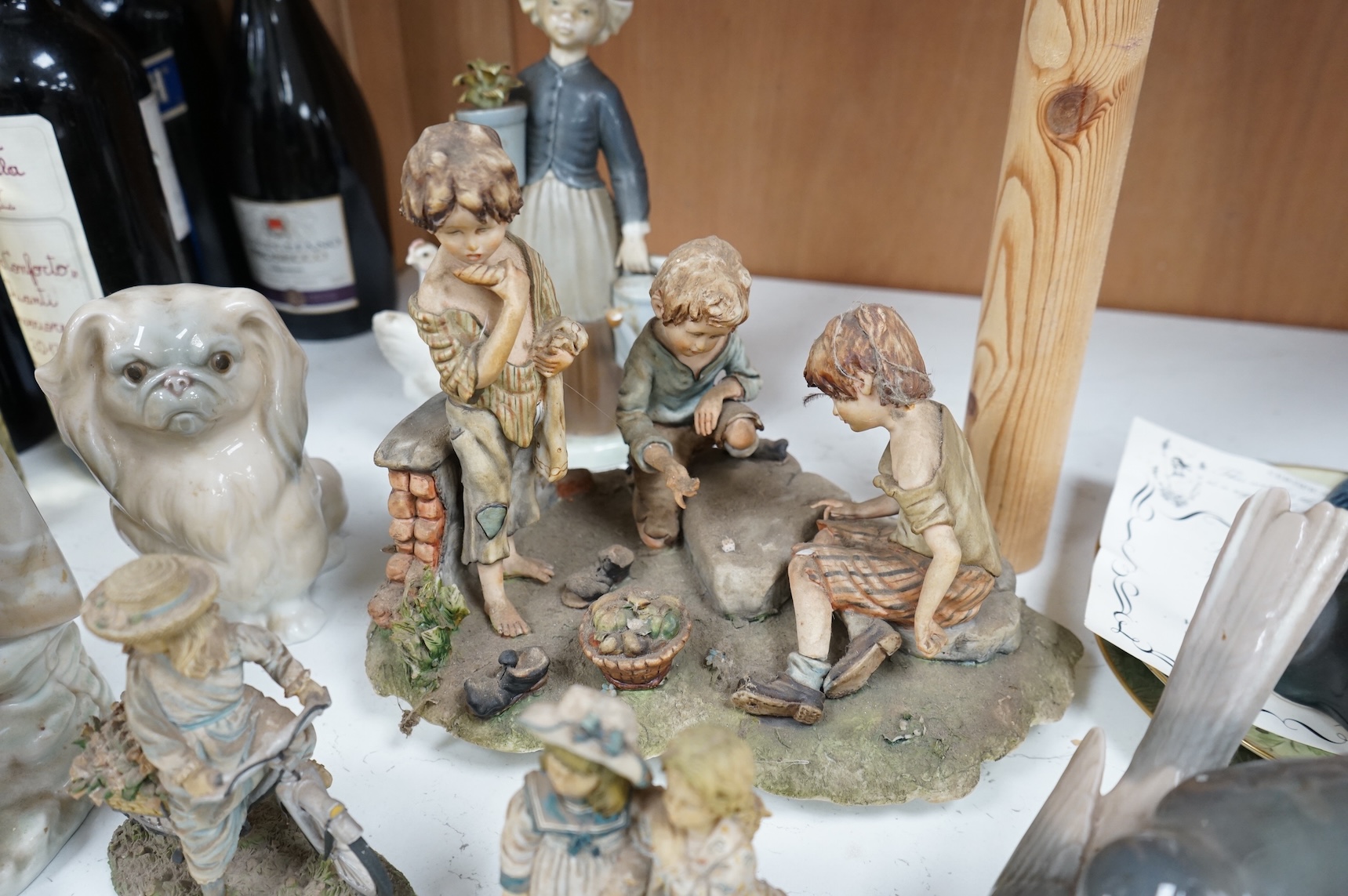 A collection of pottery and porcelain to include a Hayle model of a seal, Lladro figures and a pair of Fairy cabinet plates, largest 27cm wide